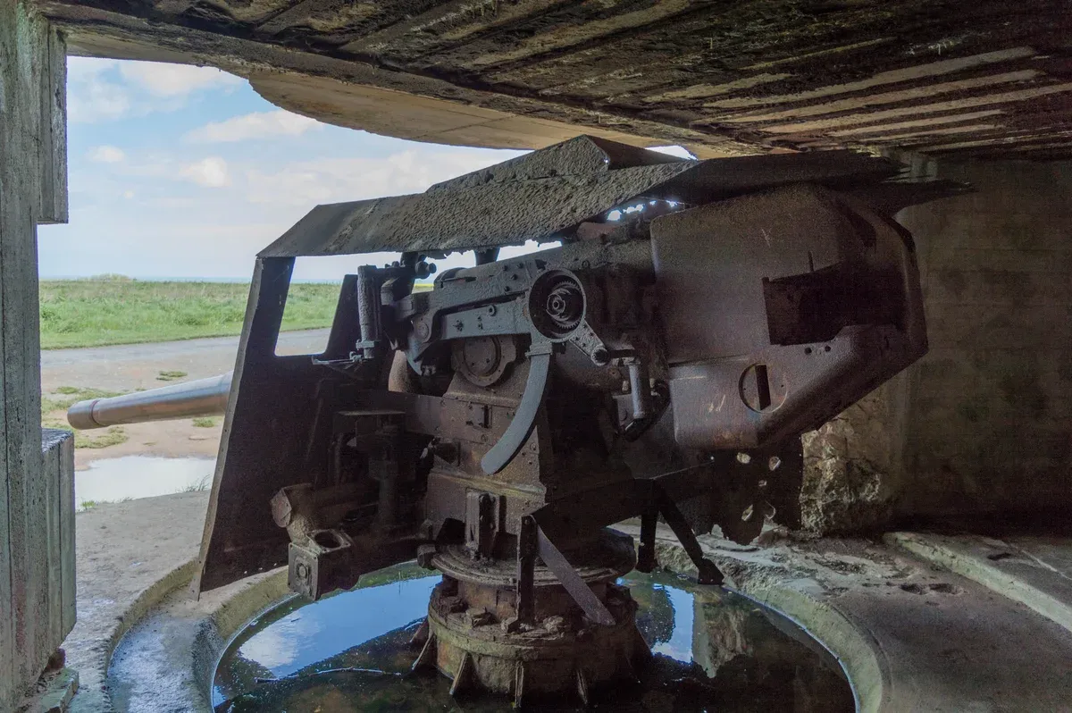 A German casemate with its gun at Longues-sur-Mer, a stop on small-group Normandy tours from Paris